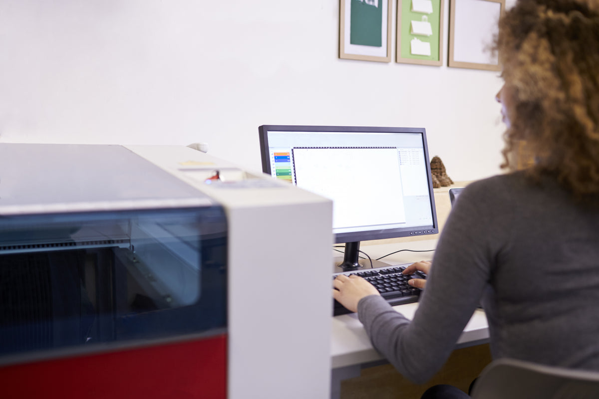 Lasersheets teacher in laser studio doing computer work